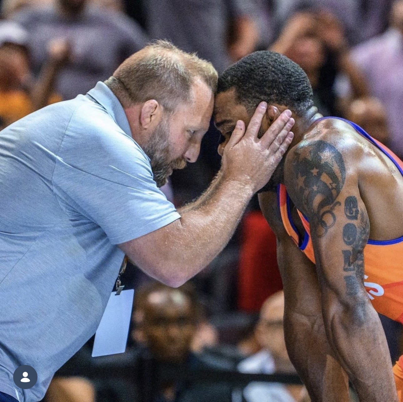 Brandon Slay coaching wrestler forehead to forehead